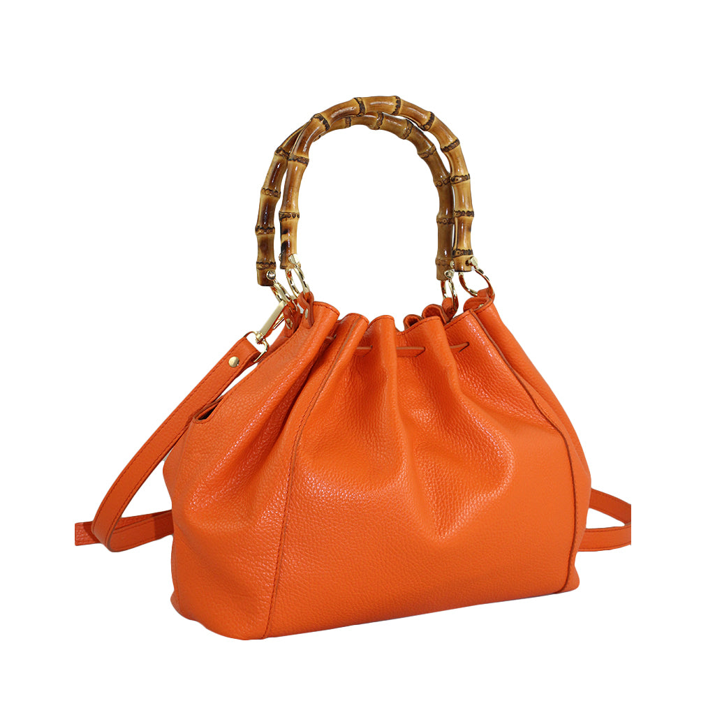 Orange leather handbag with bamboo handles and adjustable shoulder strap
