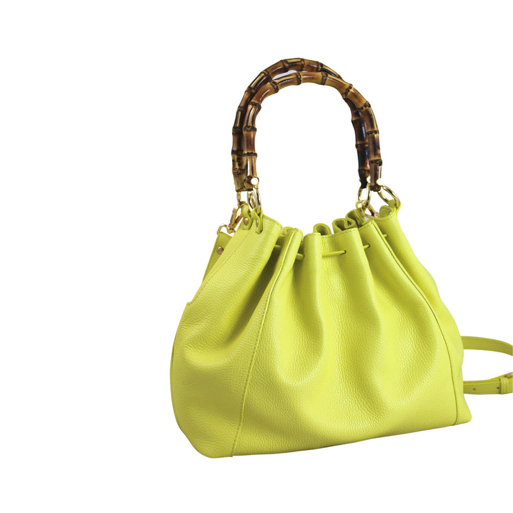 Bright yellow handbag with a textured leather finish and bamboo handle