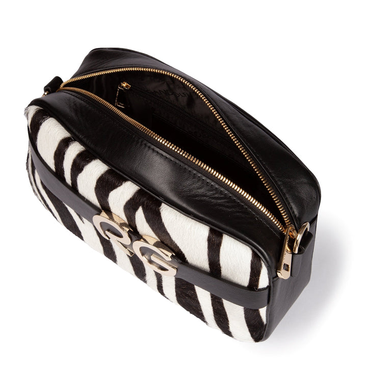 Black and white zebra pattern handbag with gold GG logo and zipper closure