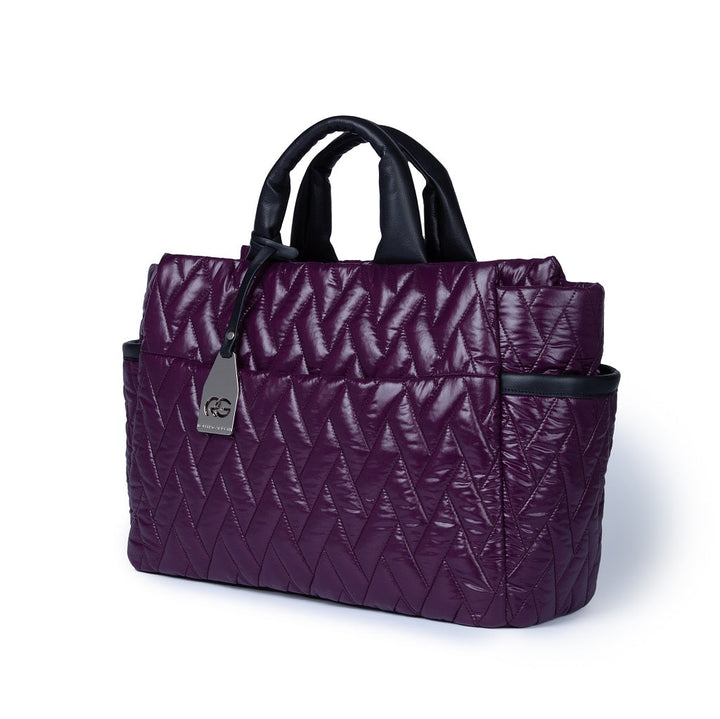 Purple quilted handbag with black handles and side pockets