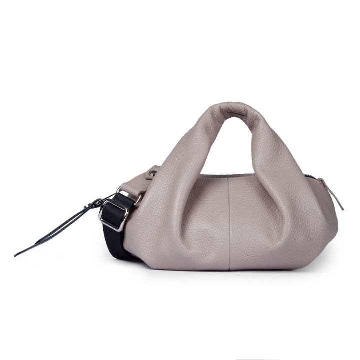 Beige leather handbag with unique twisted handle design