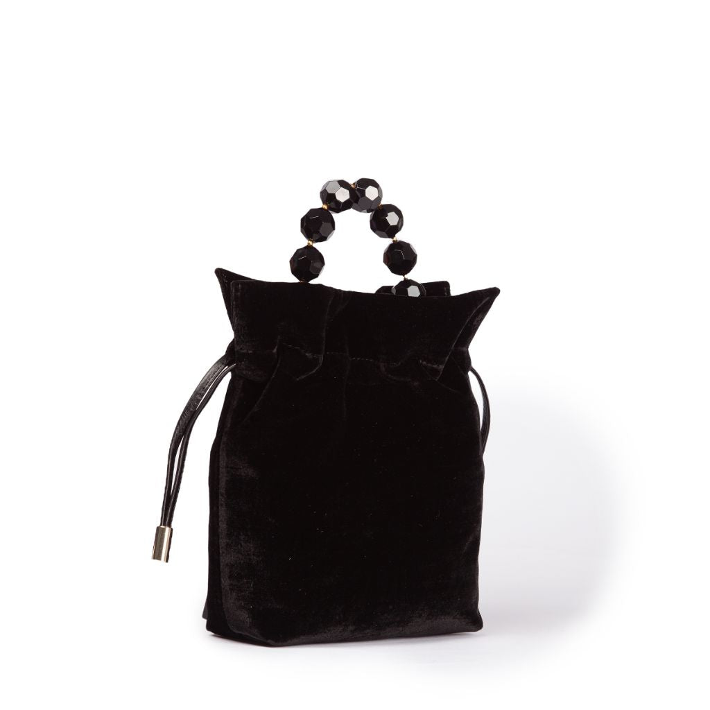 Elegant black velvet handbag with beaded handles on white background