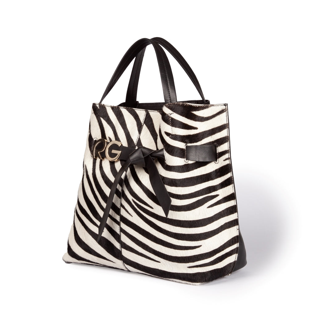 Black and white zebra print tote bag with black leather handles