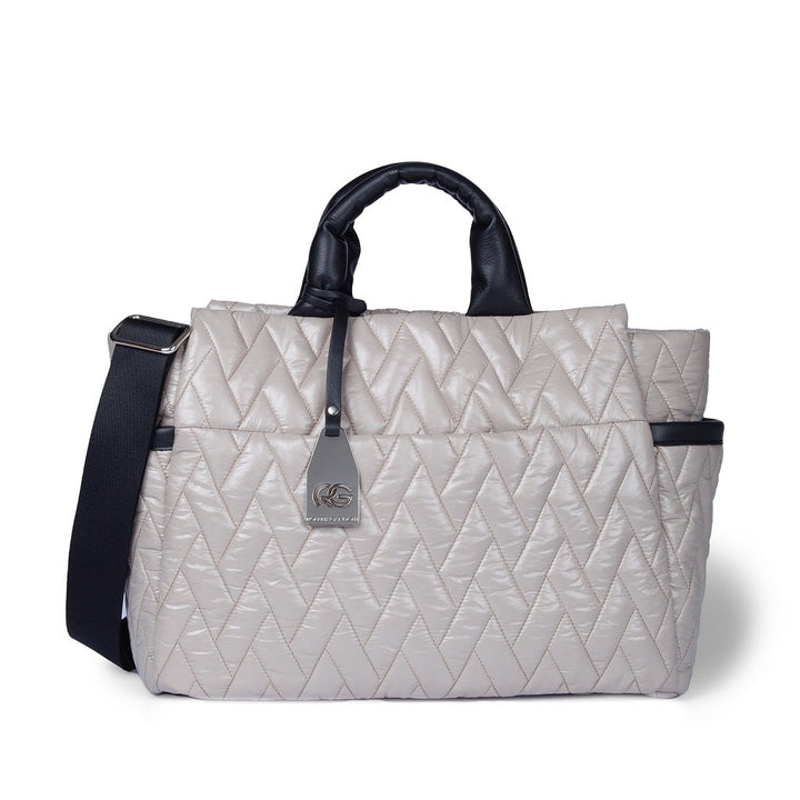 Chic quilted beige travel bag with black handles and strap