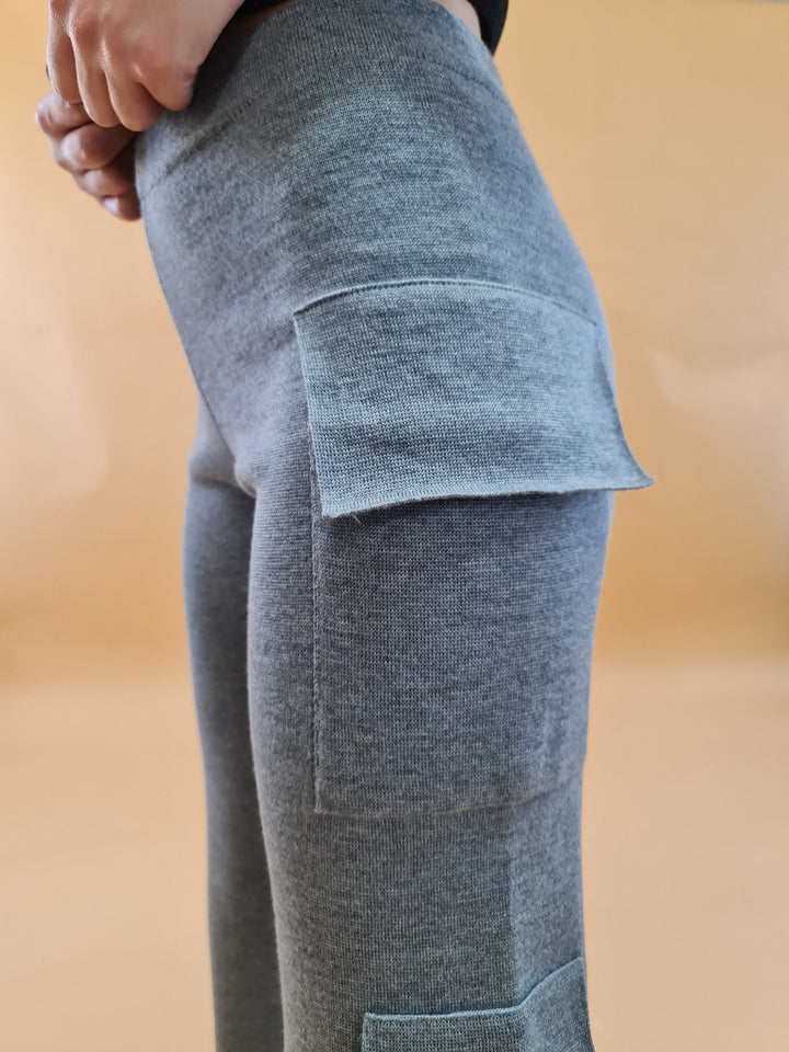 Close-up of a person wearing gray pocketed knit pants