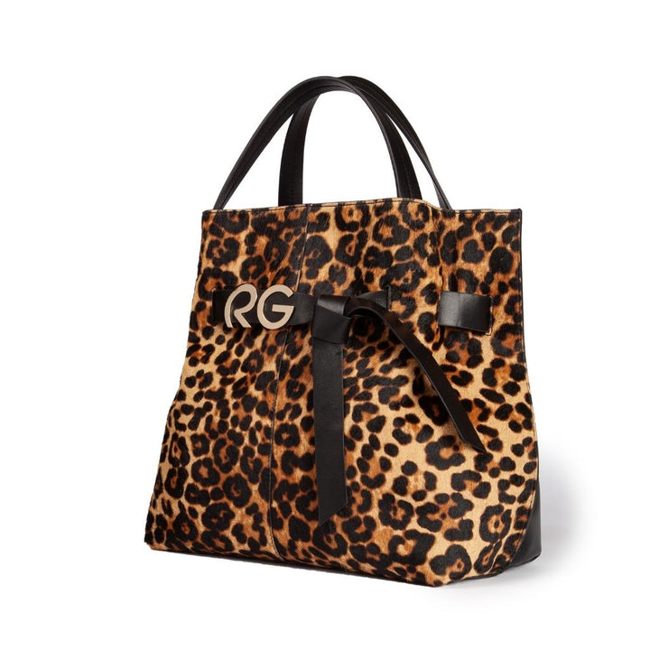 Leopard print handbag with black leather handles and bow accent