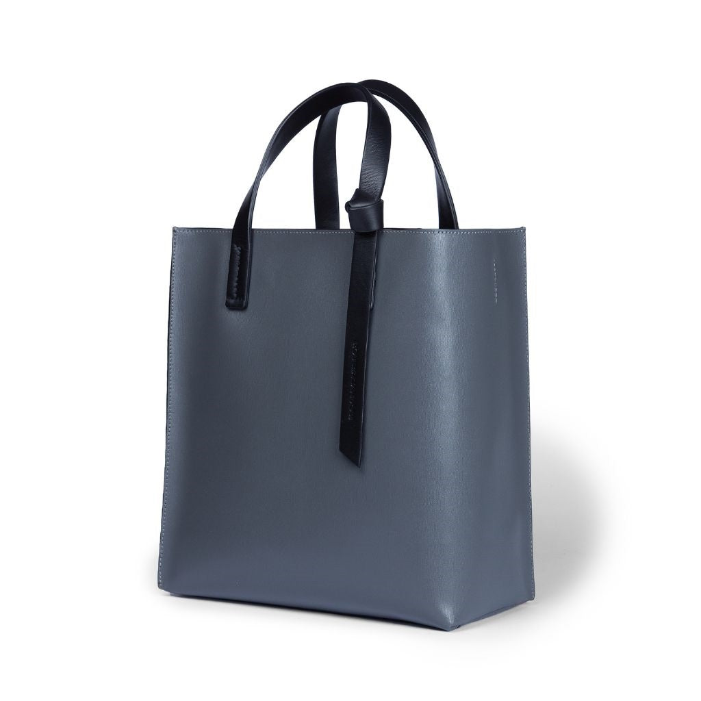 Elegant gray leather tote bag with black handles