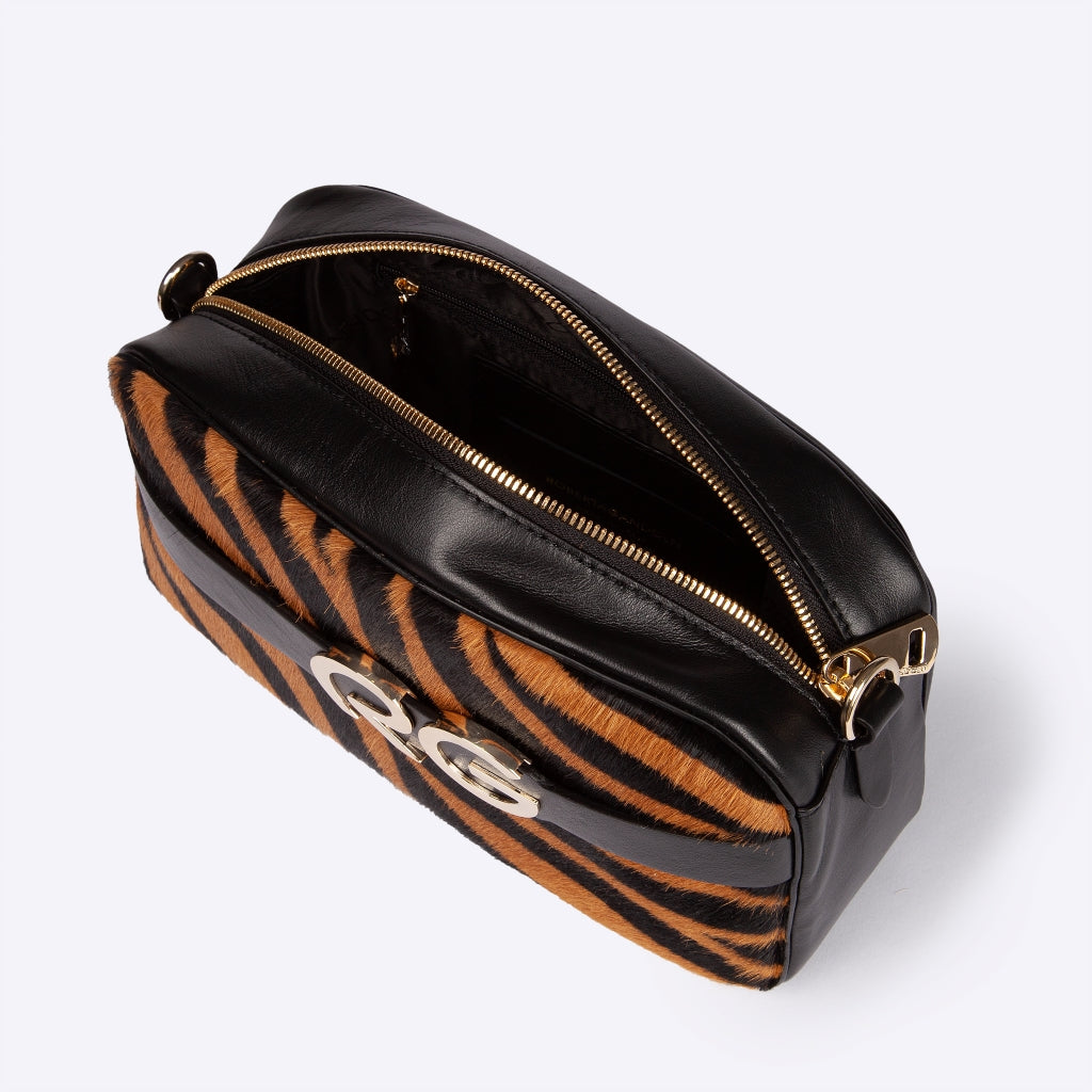 Black and tiger-striped leather luxury handbag with gold zipper and hardware