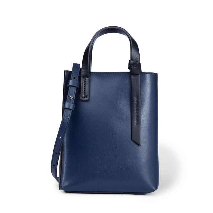 Navy blue leather tote bag with adjustable strap and handle