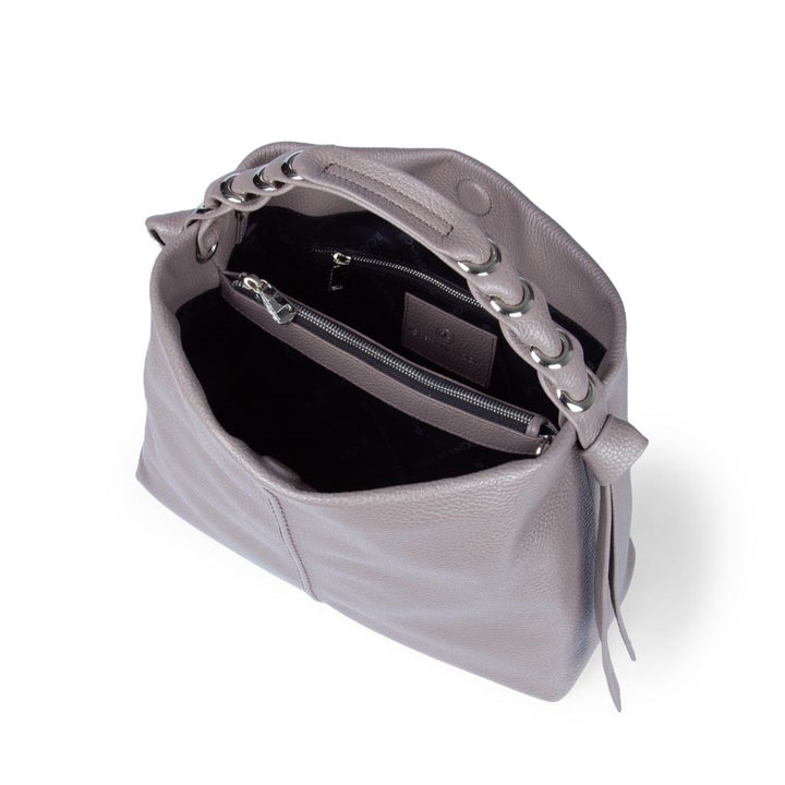 Top view of an open grey leather handbag showing interior compartments and zipper pocket