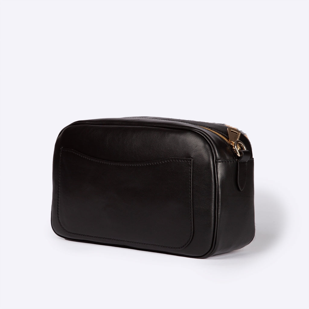 Black leather toiletry bag with gold zipper and external pocket