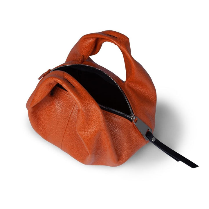 Orange leather handbag with black zipper and short handles