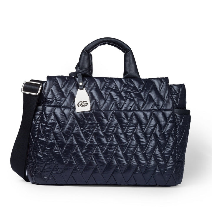 Quilted navy handbag with shoulder strap and metallic logo tag