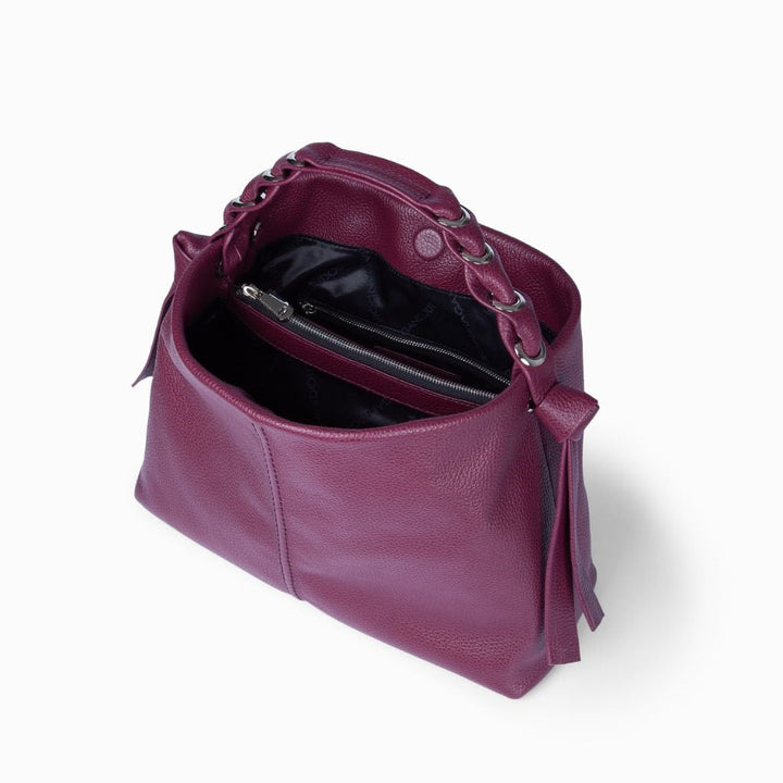 Open purple leather handbag with dark interior and zipper pocket