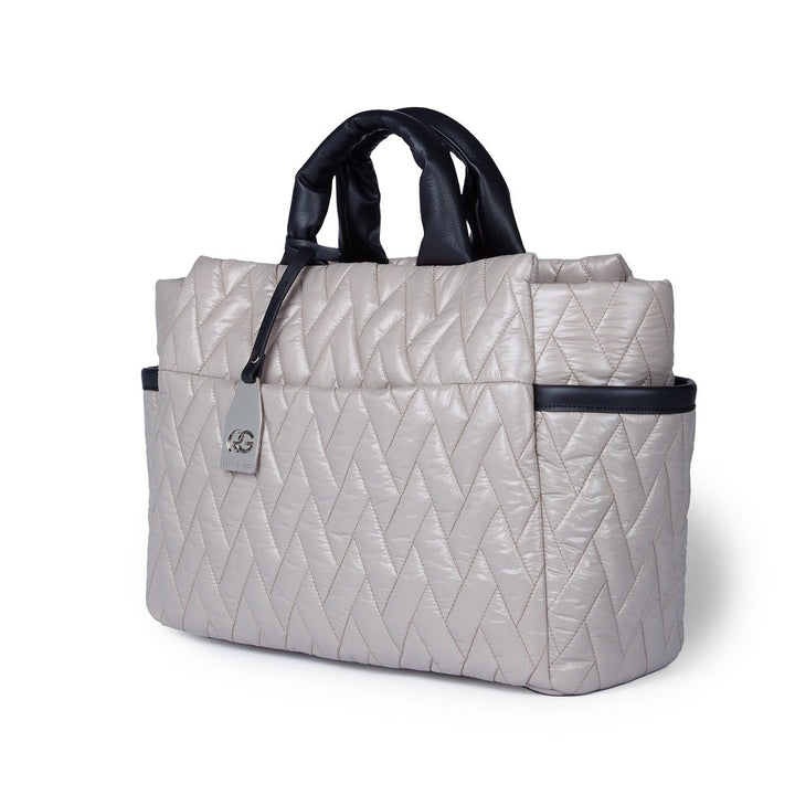 Quilted beige handbag with black handles and side pockets