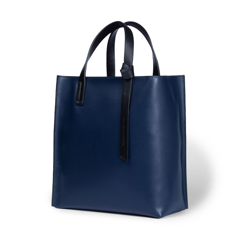 Navy blue leather tote bag with black handles