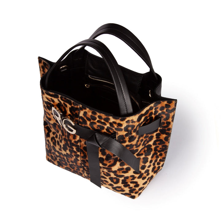 Leopard print tote bag with black leather handles and black bow accents