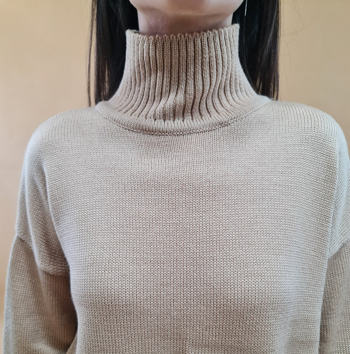 Beige turtleneck sweater on a person