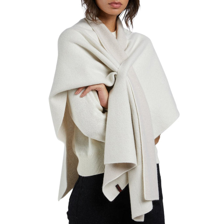 Woman wearing a white wool scarf draped over her shoulders