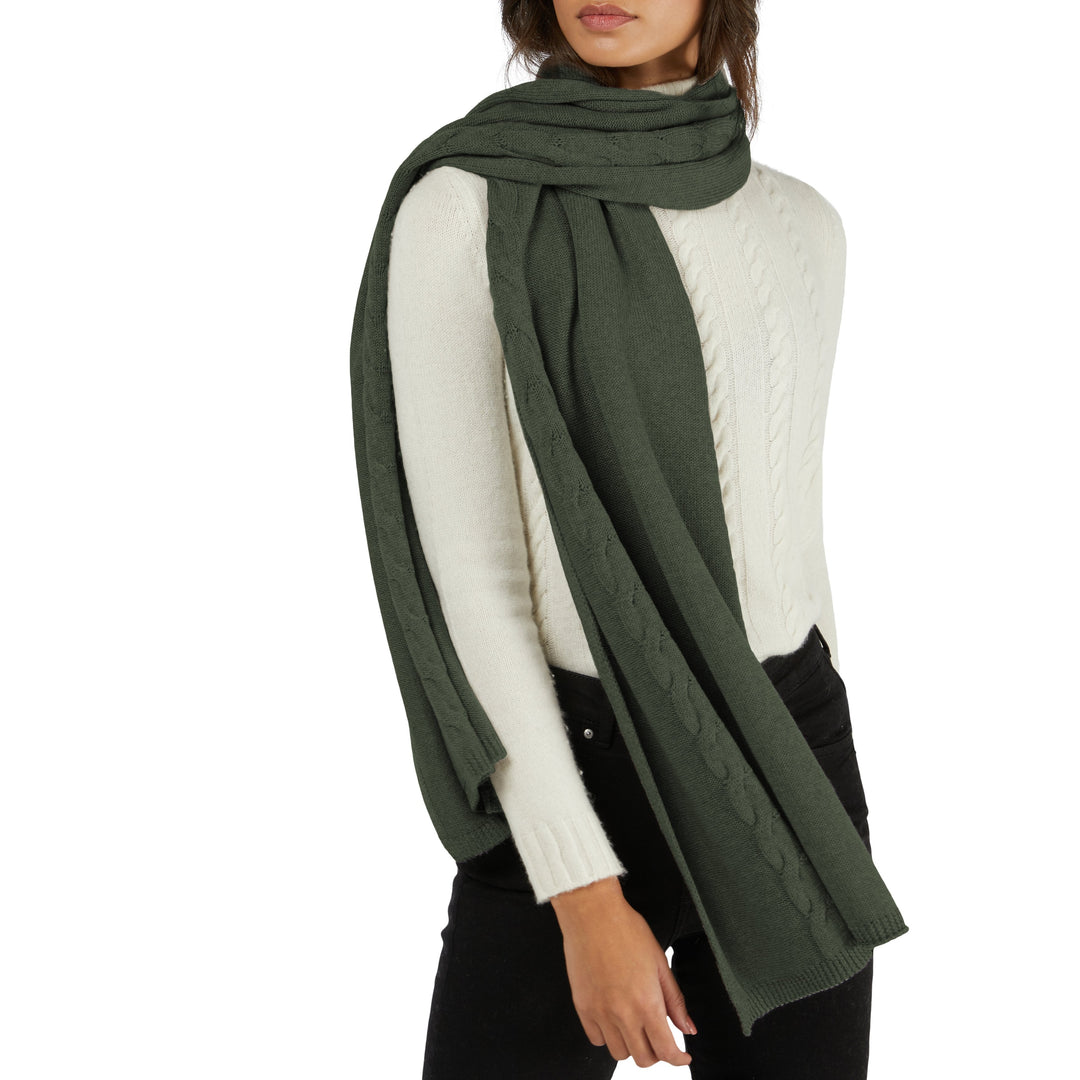 Woman wearing a green scarf and white sweater