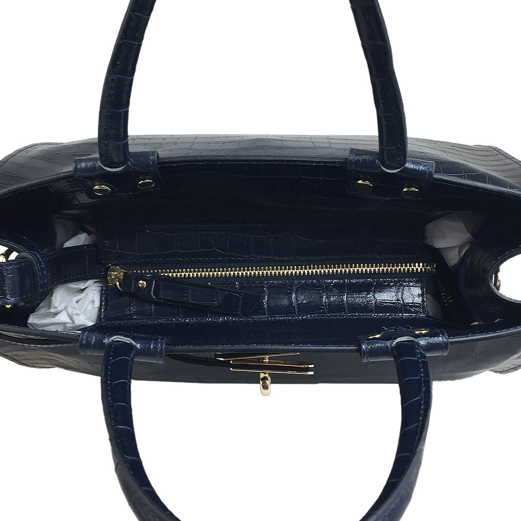 Open navy blue leather handbag showing interior compartments and gold zipper