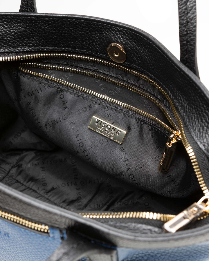 Luxury black leather handbag interior with gold zippers and logo