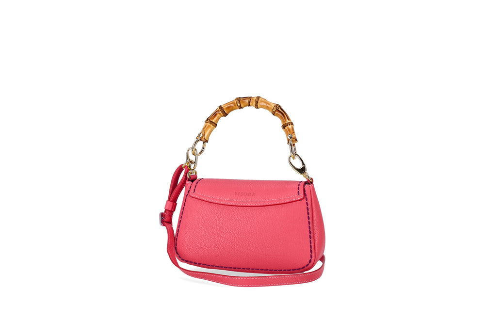 Pink leather handbag with bamboo handle and removable strap