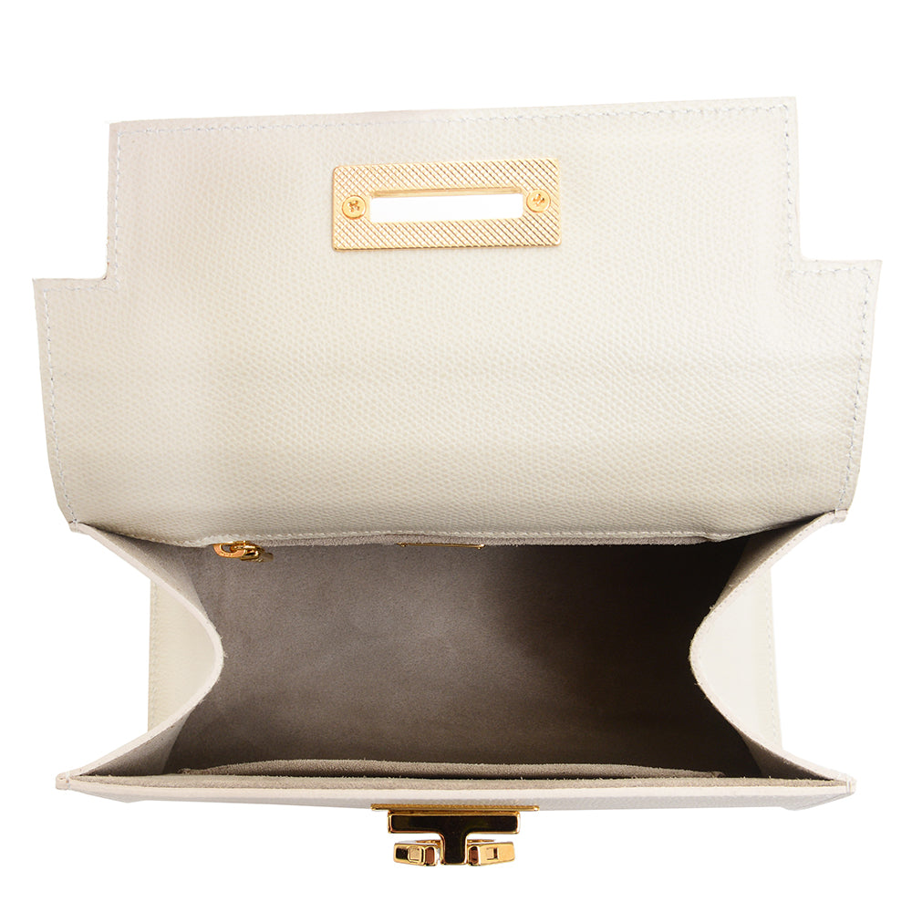 Open empty white leather clutch bag with gold hardware