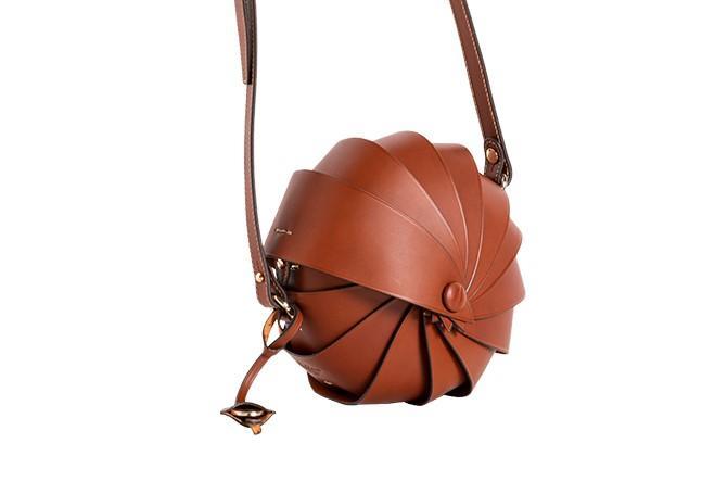 Unique brown leather spiral-shaped handbag with adjustable shoulder strap