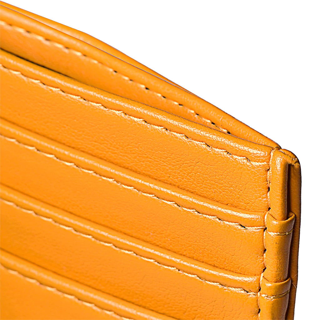 Close-up of orange leather wallet featuring stitched card slots