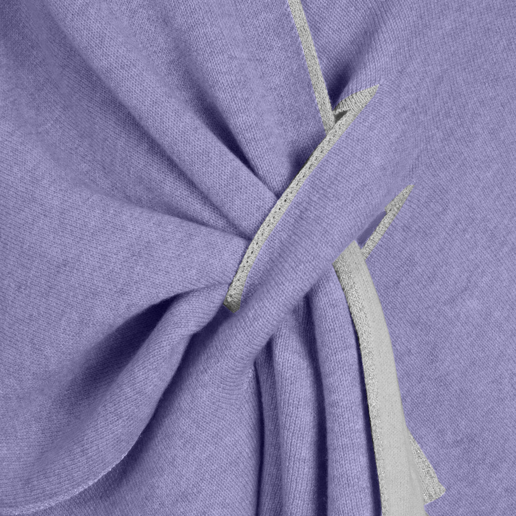 Close-up of purple fabric with a knot tied using gray strips