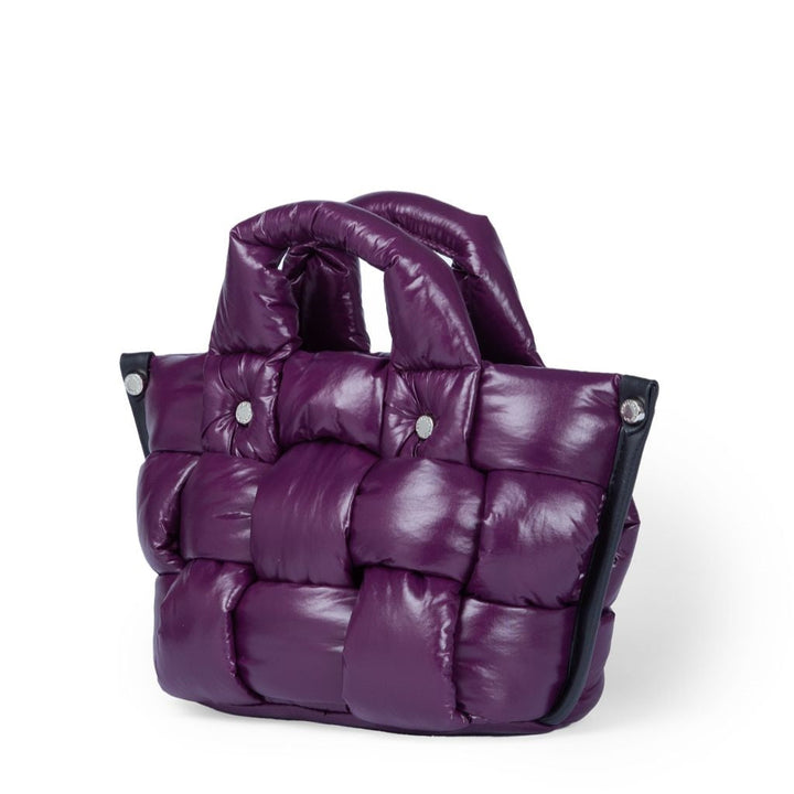 Purple quilted handbag with padded texture and button details on white background