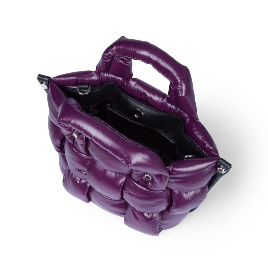 Top view of a stylish purple quilted leather handbag with an open interior