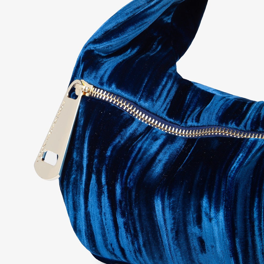 Blue velvet handbag with gold zipper detail