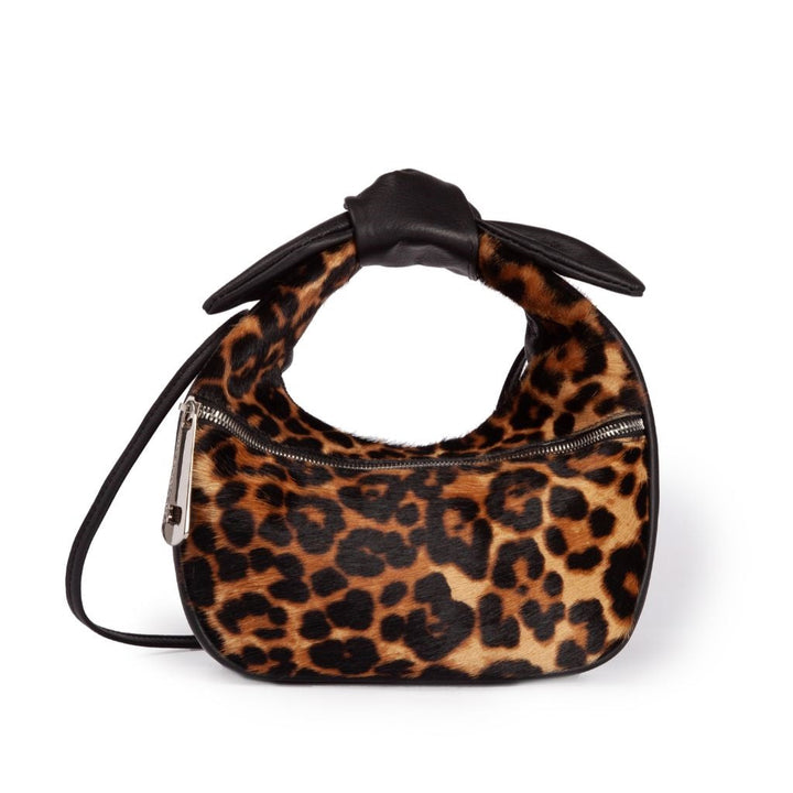 Leopard print handbag with black leather handle and zipper closure