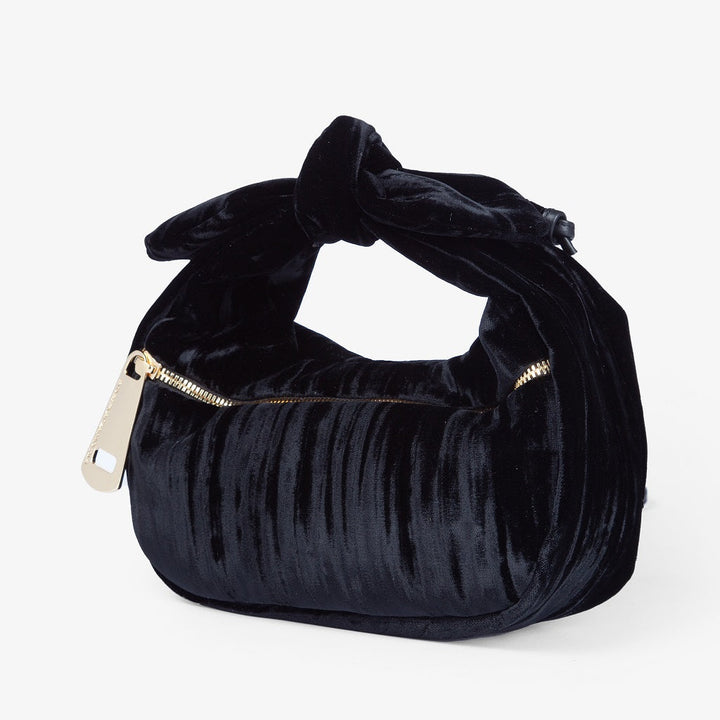 Elegant black velvet handbag with gold zipper accent and knotted handle