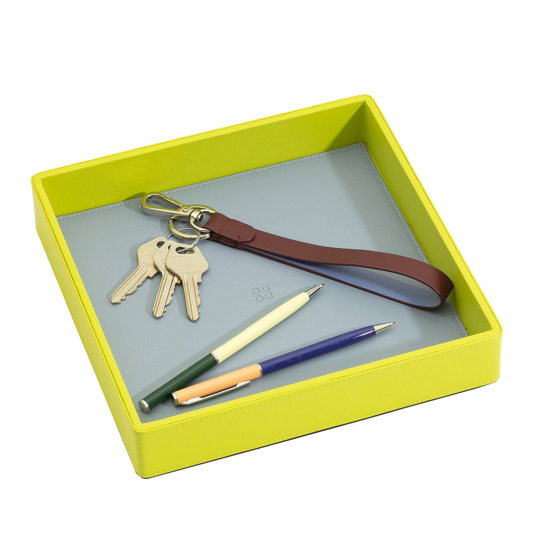 Yellow tray holding a set of keys and three pens