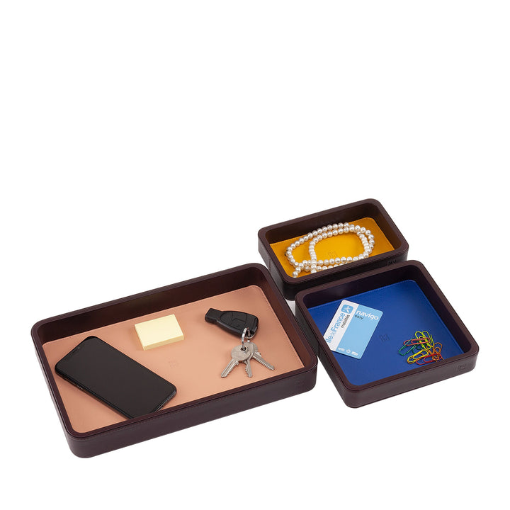 Brown leather desk organizer with compartments holding a phone, keys, sticky notes, credit card, and jewelry