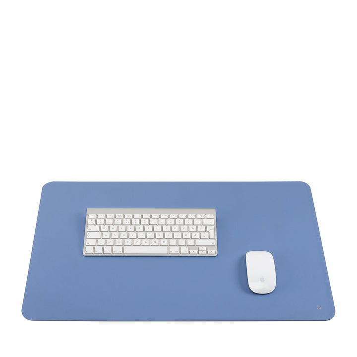 Blue desk mat with white keyboard and mouse
