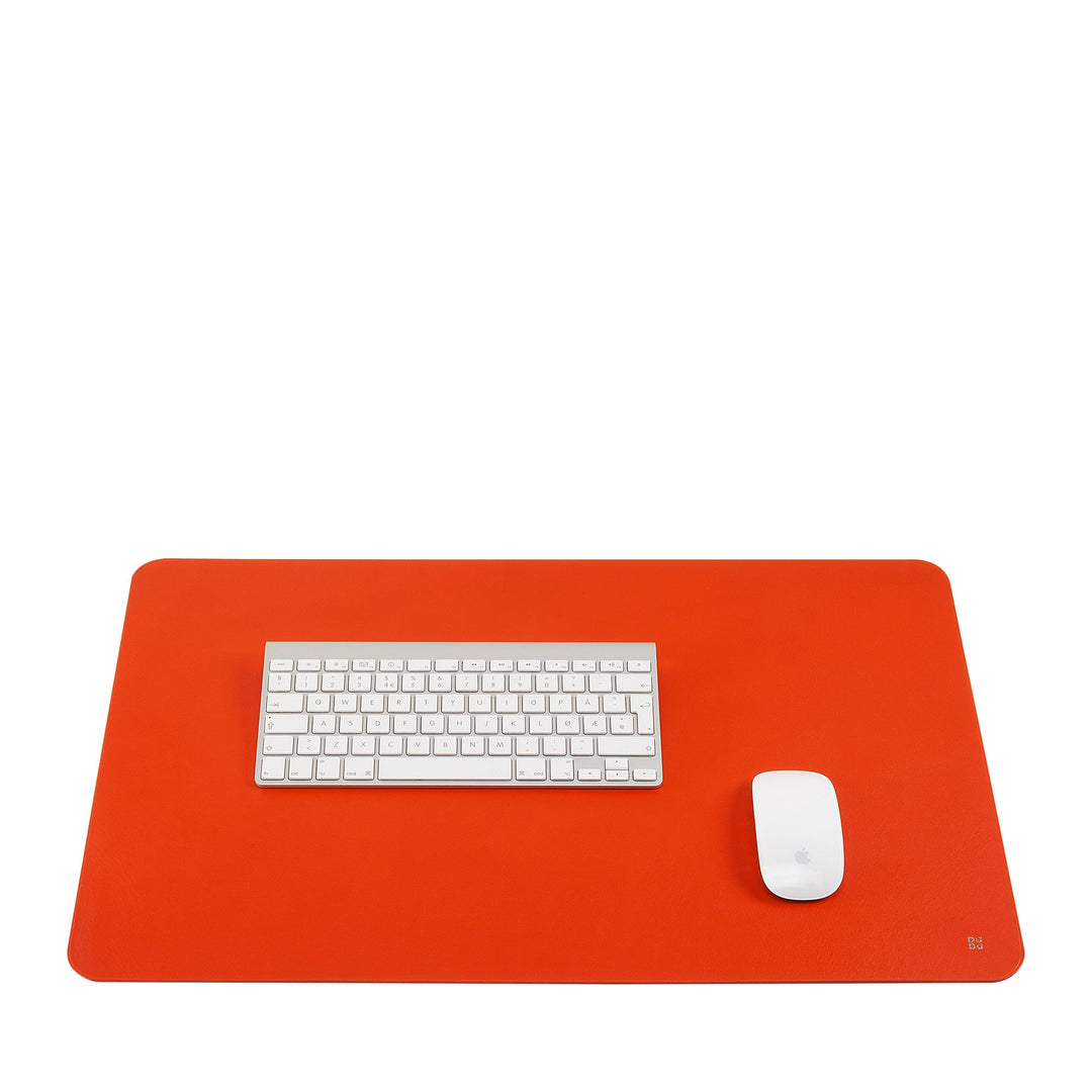 White keyboard and mouse on bright orange desk mat