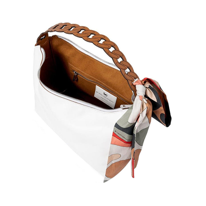 White handbag with brown braided handle and colorful scarf accessory