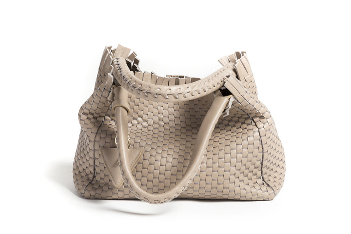 Woven beige leather handbag with braided handles and a decorative tag.