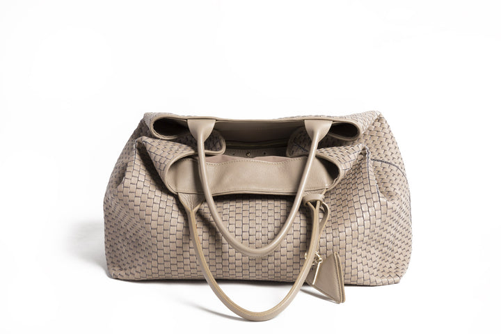 Elegant beige woven tote bag on white background.