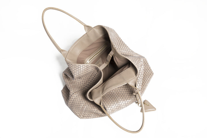 Elegant beige woven tote bag on white background.