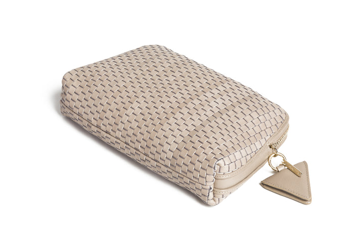 Woven beige crossbody handbag with adjustable strap and zipper closure.