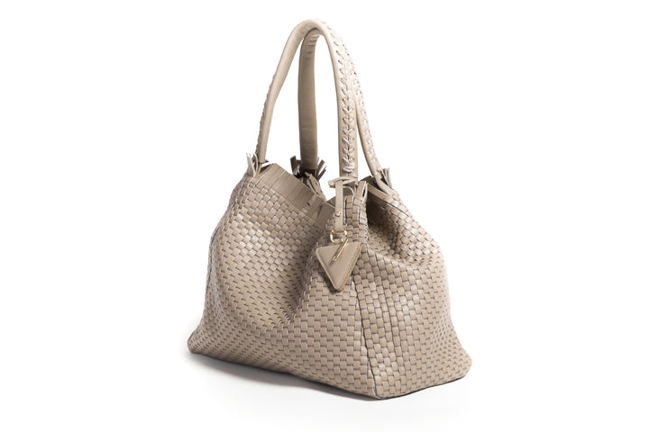 Elegant beige woven handbag with dual handles and tag.