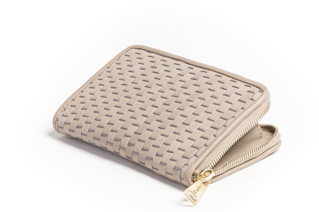 Woven beige leather wallet with zipper on white background.