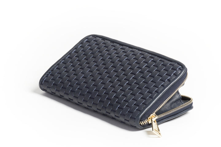 Black woven leather wallet on a white background.