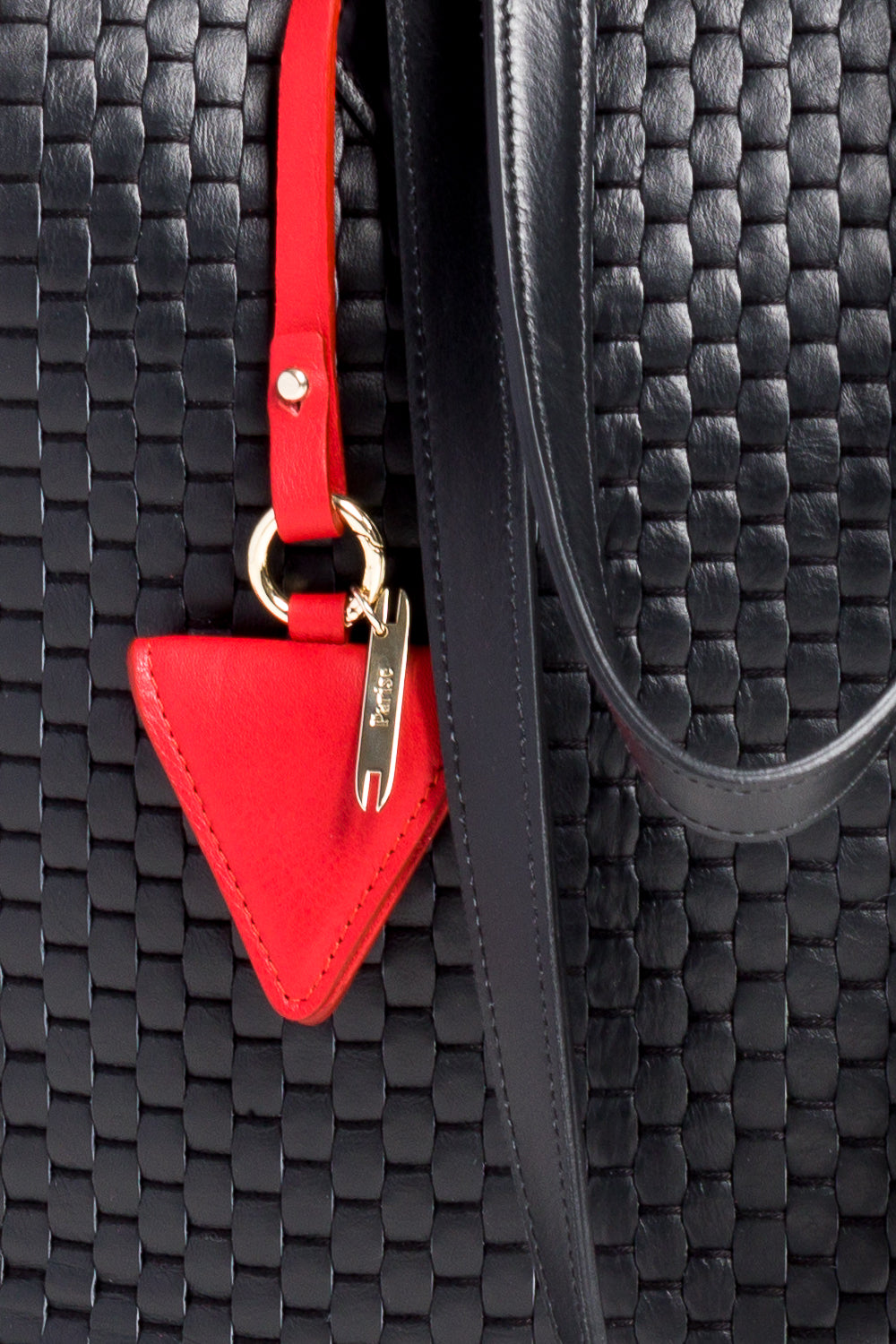 Red triangle leather keychain with strap on white background.