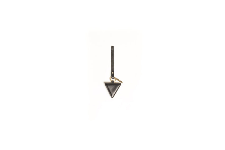 Minimalist black triangle leather keychain on a white background.